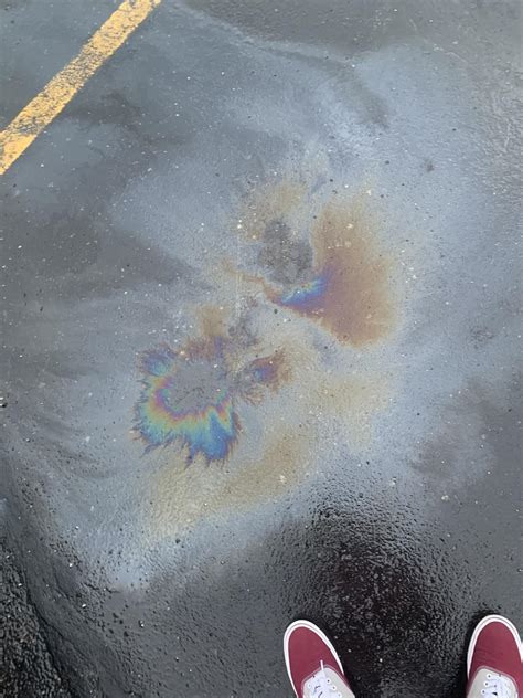 rainbow leak under car|Rainbow coloured trail of liquid (substance ) from。